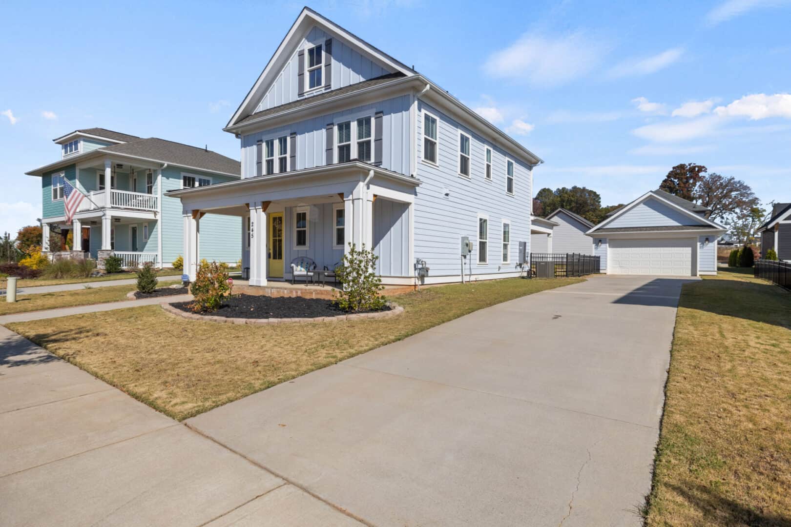 A two story home with a driveway in front of it.