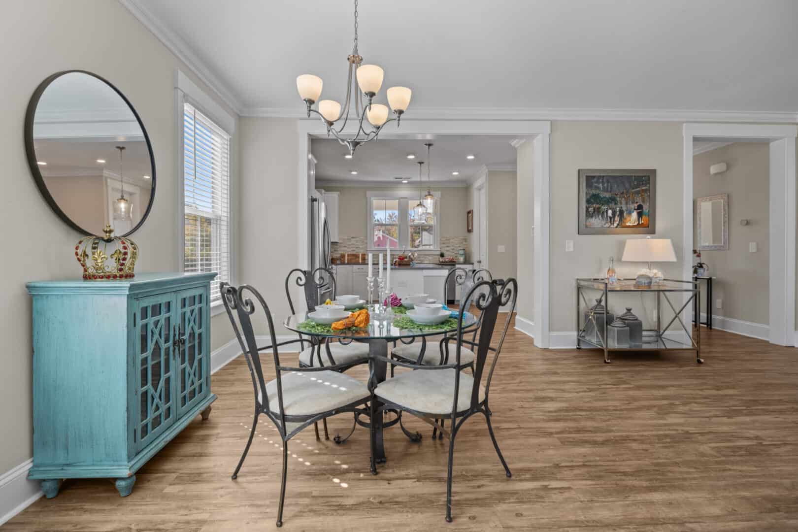 A dining room in a home with hardwood floors.