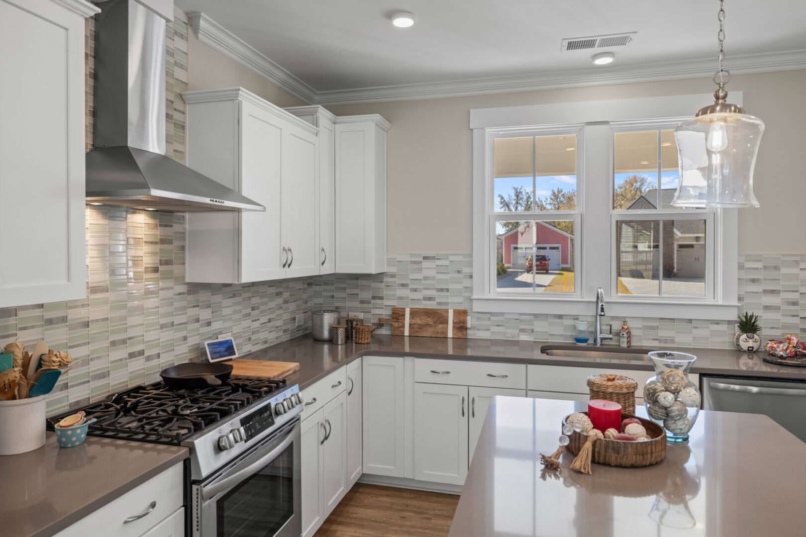 A kitchen with white cabinets and stainless steel appliances.