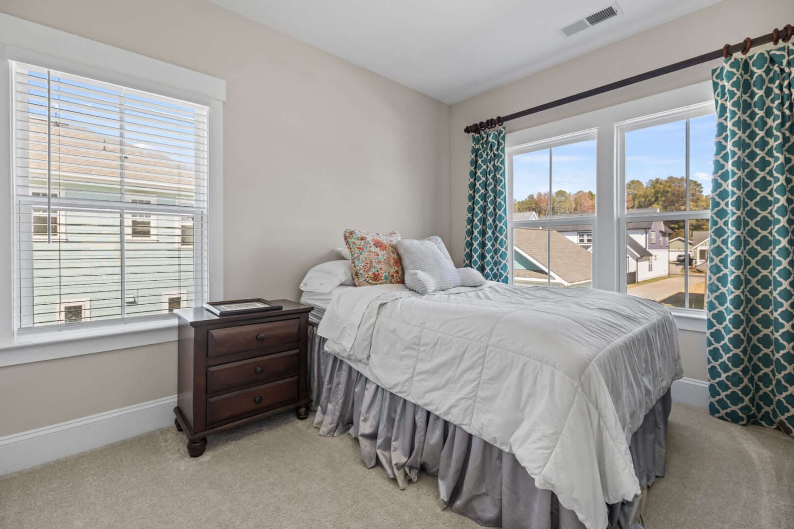 A bedroom with a bed and a window.