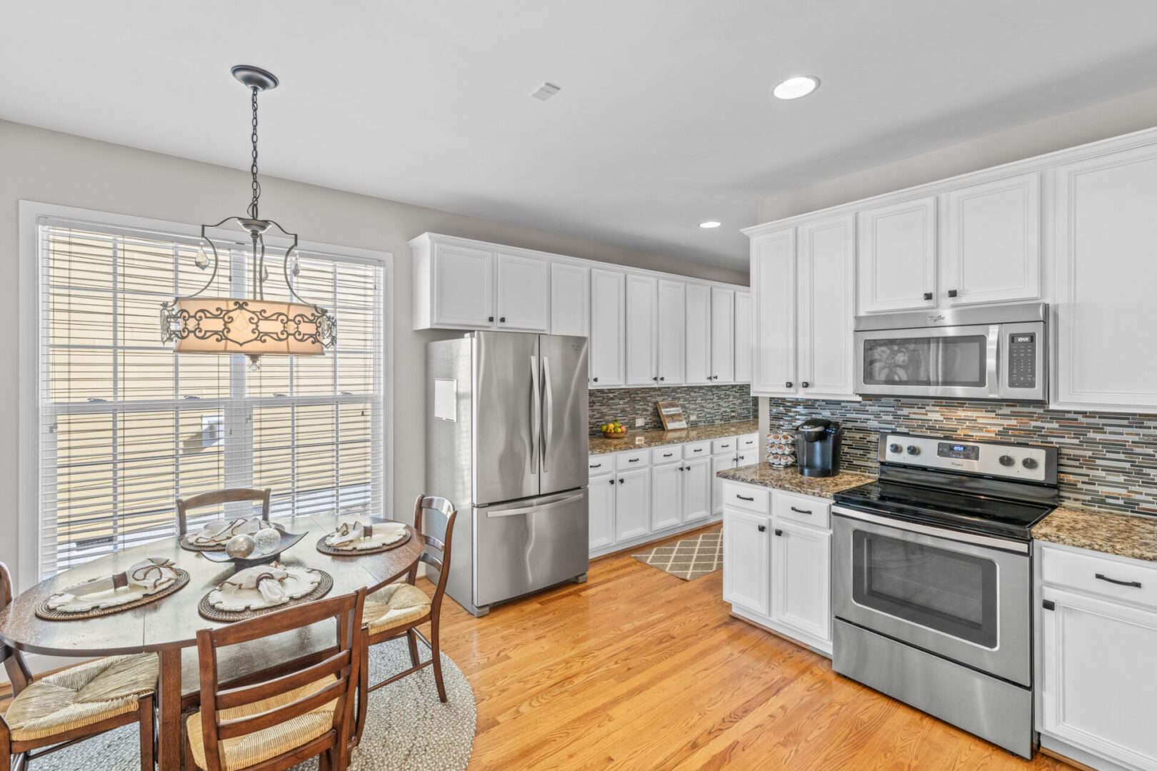 A kitchen with white cabinets and stainless steel appliances.