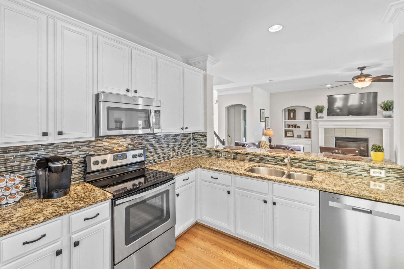 A kitchen with white cabinets and stainless steel appliances.